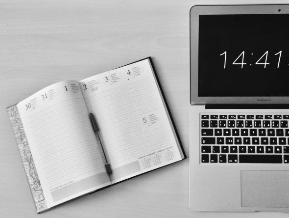 Laptop showing time and daily routine planner to track your time on various activities